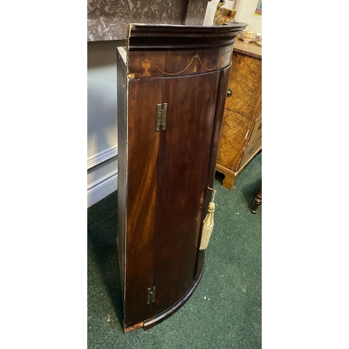 52 - A GEORGIAN BOW FRONTED HANGING CORNER CABINET, with a graduated pediment top, over a row of inlaid u... 