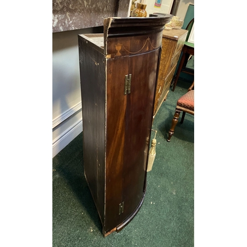 52 - A GEORGIAN BOW FRONTED HANGING CORNER CABINET, with a graduated pediment top, over a row of inlaid u... 