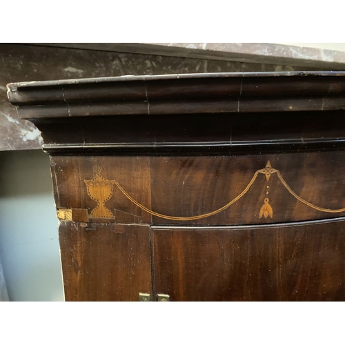 52 - A GEORGIAN BOW FRONTED HANGING CORNER CABINET, with a graduated pediment top, over a row of inlaid u... 