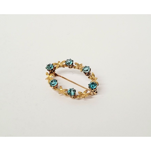 6 - A CASED 9CT YELLOW GOLD & TOPAZ BLUE GEMSTONE SET BROOCH, the brooch decorated with floral design an... 