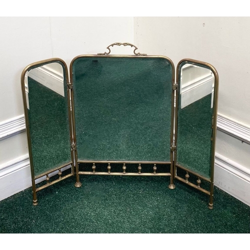 63 - A 19TH CENTURY BRASS THREE PANEL MIRRORED FIRESCREEN, with arched mirrors, ornate handle to central ... 