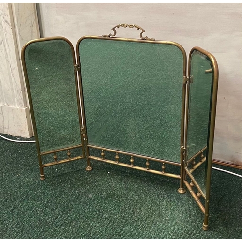 63 - A 19TH CENTURY BRASS THREE PANEL MIRRORED FIRESCREEN, with arched mirrors, ornate handle to central ... 