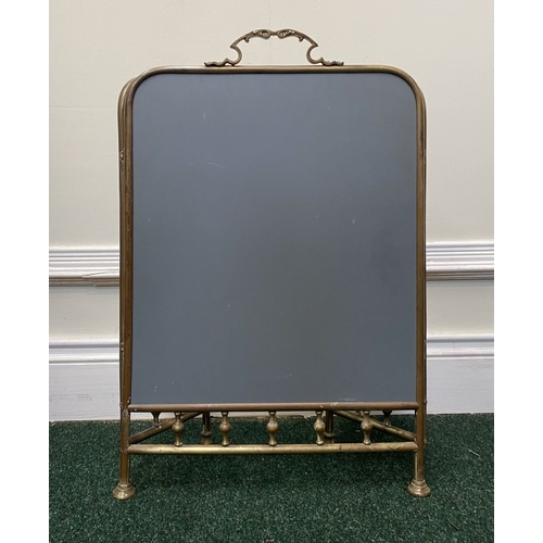 63 - A 19TH CENTURY BRASS THREE PANEL MIRRORED FIRESCREEN, with arched mirrors, ornate handle to central ... 