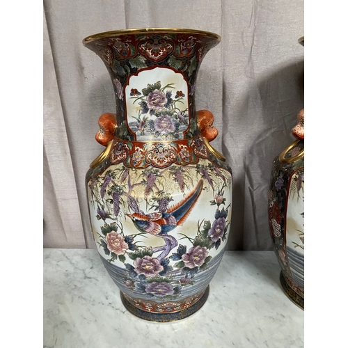 94 - A LARGE DECORATIVE PAIR OF IMARI VASES, with panels to front and reverse featuring birds amongst fol... 