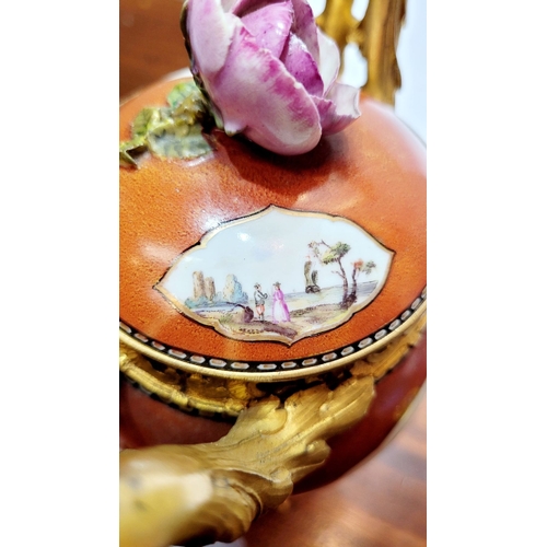 96 - AN ORMOLU MOUNTED MEISSEN PORCELAIN LIDDED VESSEL, the lid mounted with a rose blossom finial, the b... 