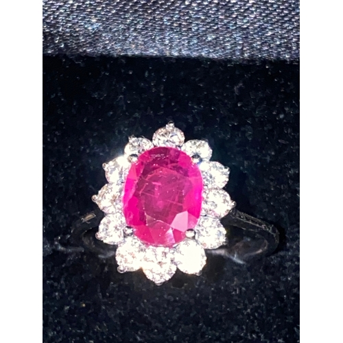 138 - AN EXCELLENT 18CT BURMESE RUBY AND DIAMOND CLUSTER RING, striking oval cut Burmese ruby in four claw... 