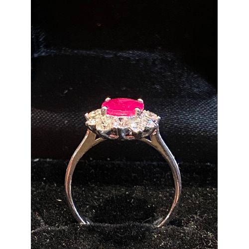 138 - AN EXCELLENT 18CT BURMESE RUBY AND DIAMOND CLUSTER RING, striking oval cut Burmese ruby in four claw... 