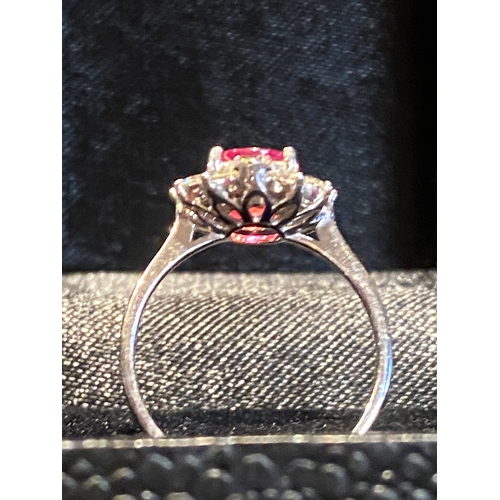 138 - AN EXCELLENT 18CT BURMESE RUBY AND DIAMOND CLUSTER RING, striking oval cut Burmese ruby in four claw... 