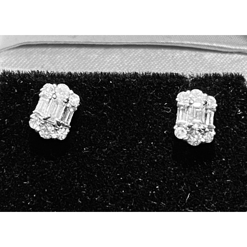 183 - A TIMELESS PAIR OF 18CT WHITE GOLD BAGUETTE CUT DIAMONDS STUD EARRINGS, with baguette and round cut ... 