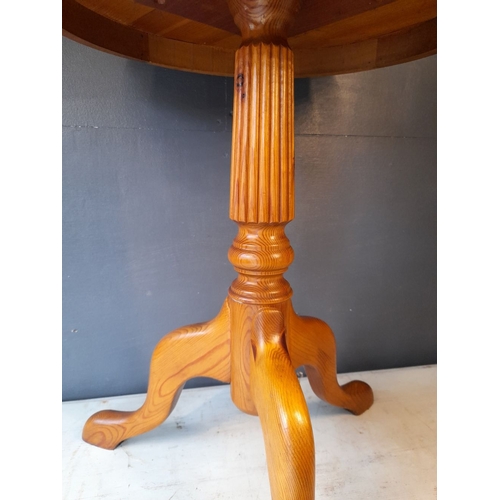 104 - A NICE CIRCULAR PINE SIDE TABLE, circular top with fluted turned support, standing on tripod base wi... 