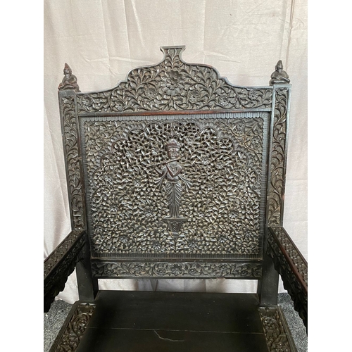 11 - AN IMPRESSIVE CARVED THRONE STYLE HARDWOOD CHAIR, decorated all over with scrolling foliage detail; ... 