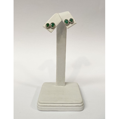 115 - A BEAUTIFUL PAIR OF HAND-AMDE 18CT WHITE GOLD EMERALD & DIAMOND EARRINGS, each with two oval cut eme... 