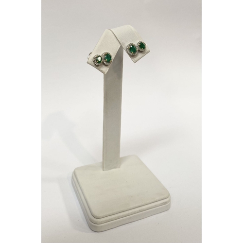 115 - A BEAUTIFUL PAIR OF HAND-AMDE 18CT WHITE GOLD EMERALD & DIAMOND EARRINGS, each with two oval cut eme... 