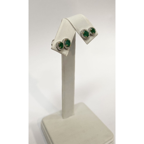 115 - A BEAUTIFUL PAIR OF HAND-AMDE 18CT WHITE GOLD EMERALD & DIAMOND EARRINGS, each with two oval cut eme... 