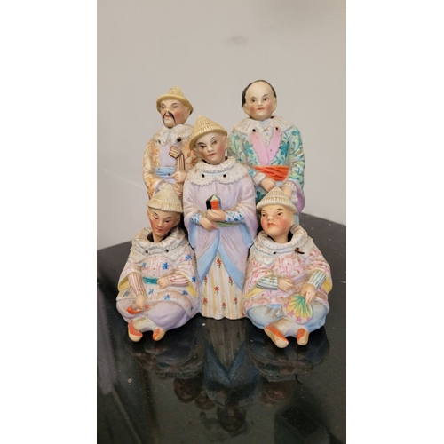 117 - A BISQUE PORCELAIN GROUP OF 'BOBBING HEAD' FIGURES, in Asian attire, the head of each figure bobs. P... 