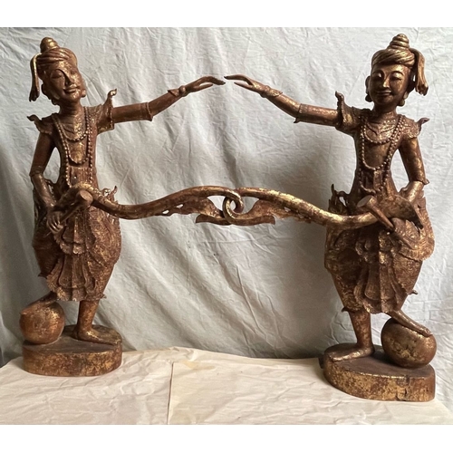 128 - A PAIR OF HAND CARVED THAI FIGURES, each wooden figure has a gilt finish, 
the figures stand with on... 