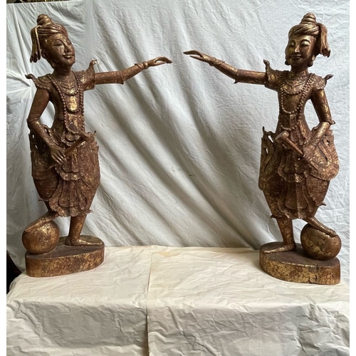 128 - A PAIR OF HAND CARVED THAI FIGURES, each wooden figure has a gilt finish, 
the figures stand with on... 