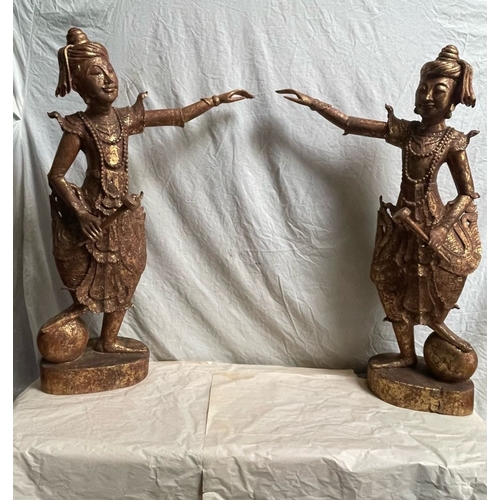 128 - A PAIR OF HAND CARVED THAI FIGURES, each wooden figure has a gilt finish, 
the figures stand with on... 