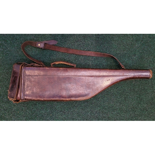 130 - A VINTAGE LEATHER HANDSTITCHED GUN CASE, with old travel labels attached, the interior could do with... 