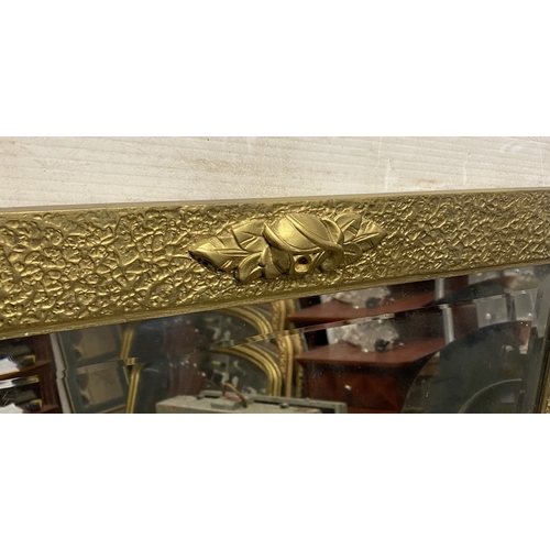 178 - A GOOD ART DECO STYLE GILT OVERMANTLE/HALL MIRROR, the rectangular bevelled glass in heavy gilt hard... 