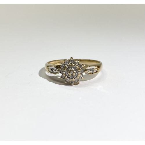 24 - A BEAUTIFUL DIA GOLD DIAMOND CLUSTER RING, with central round cut diamond surrounded by row of six d... 