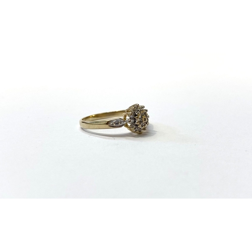 24 - A BEAUTIFUL DIA GOLD DIAMOND CLUSTER RING, with central round cut diamond surrounded by row of six d... 