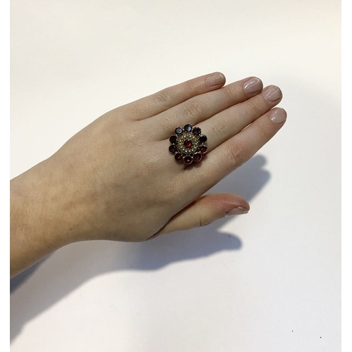 3 - A BEAUTIFUL GARNET SEEDED PEARL 9CT GOLD CLUSTER RING, with central garnet surrounded by row of seed... 