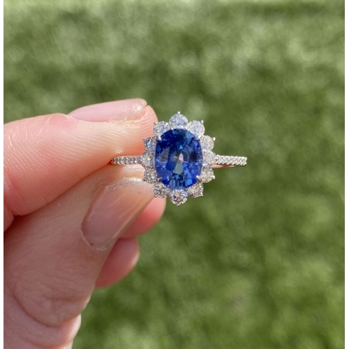 31 - AN 18CT WHITE GOLD CEYLON SAPPHIRE AND DIAMOND CLUSTER RING, with central vibrant Ceylon sapphire in... 