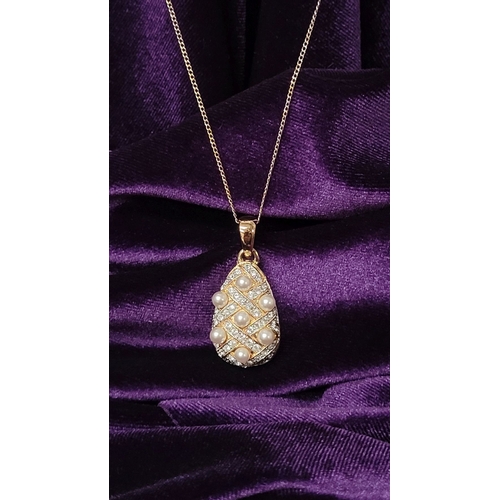 53 - A BEAUTIFUL 14CT YELLOW GOLD CHAIN & PENDANT, the pendant of pear shape with seed pearls dotted abou... 