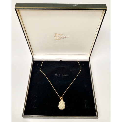 53 - A BEAUTIFUL 14CT YELLOW GOLD CHAIN & PENDANT, the pendant of pear shape with seed pearls dotted abou... 