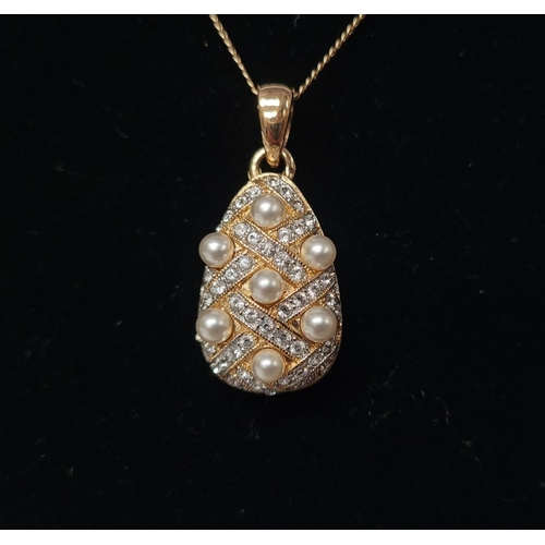 53 - A BEAUTIFUL 14CT YELLOW GOLD CHAIN & PENDANT, the pendant of pear shape with seed pearls dotted abou... 