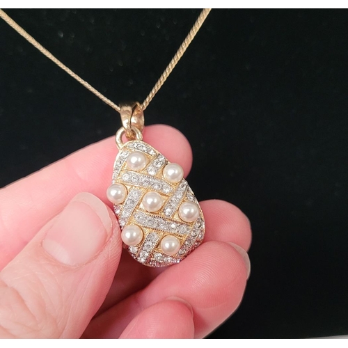 53 - A BEAUTIFUL 14CT YELLOW GOLD CHAIN & PENDANT, the pendant of pear shape with seed pearls dotted abou... 