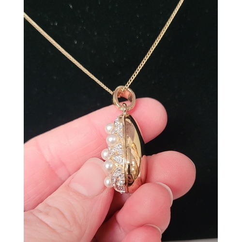 53 - A BEAUTIFUL 14CT YELLOW GOLD CHAIN & PENDANT, the pendant of pear shape with seed pearls dotted abou... 