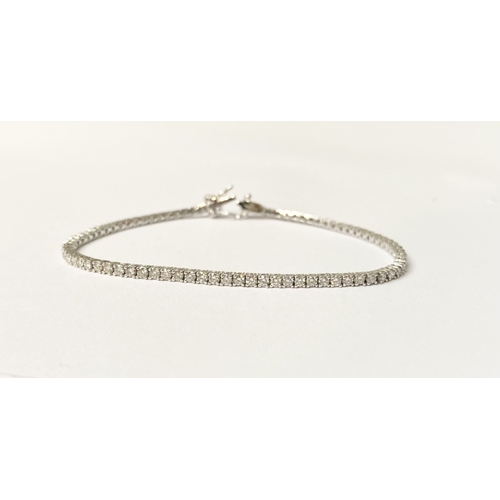 64 - A FANTASTIC 9CT WHITE GOLD DIAMOND TENNIS BRACELET, with 2.20cts total diamonds, complete with safet... 