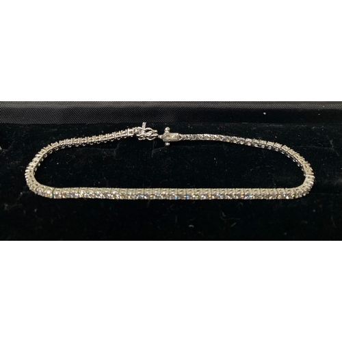 64 - A FANTASTIC 9CT WHITE GOLD DIAMOND TENNIS BRACELET, with 2.20cts total diamonds, complete with safet... 