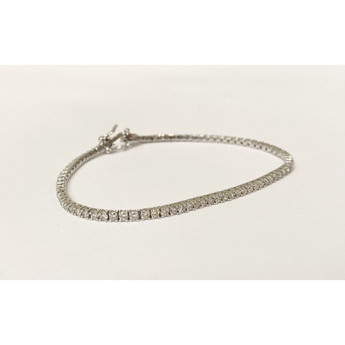 64 - A FANTASTIC 9CT WHITE GOLD DIAMOND TENNIS BRACELET, with 2.20cts total diamonds, complete with safet... 