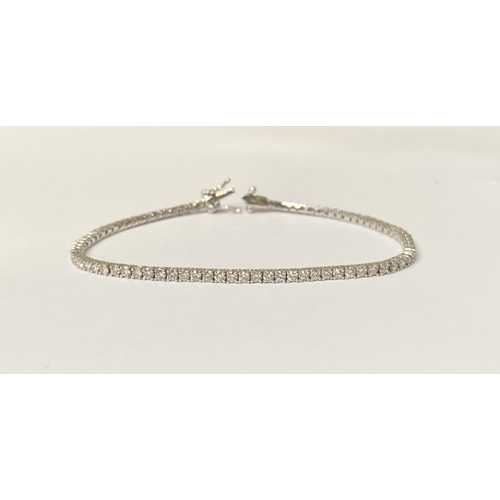 64 - A FANTASTIC 9CT WHITE GOLD DIAMOND TENNIS BRACELET, with 2.20cts total diamonds, complete with safet... 