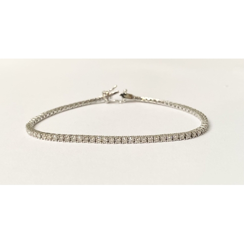 64 - A FANTASTIC 9CT WHITE GOLD DIAMOND TENNIS BRACELET, with 2.20cts total diamonds, complete with safet... 