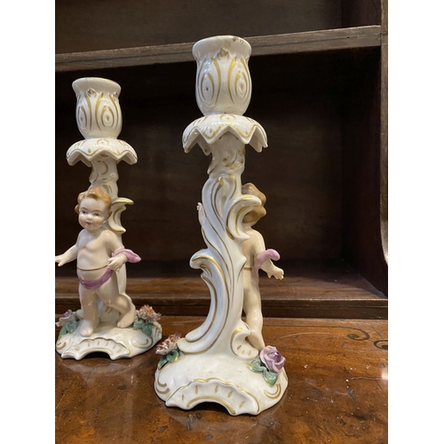 78 - THREE EARLY 20TH CENTURY GERMAN PORCELAIN CHERUB CANDLESTICKS, marked to base with blue mark featuri... 