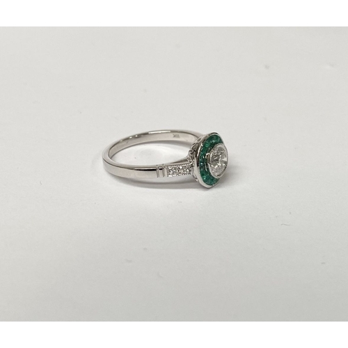 8 - AN ART DECO STYLE 18CT WHITE GOLD COLUMBIAN EMERALD AND DIAMOND TARGET RING, with central round bril... 