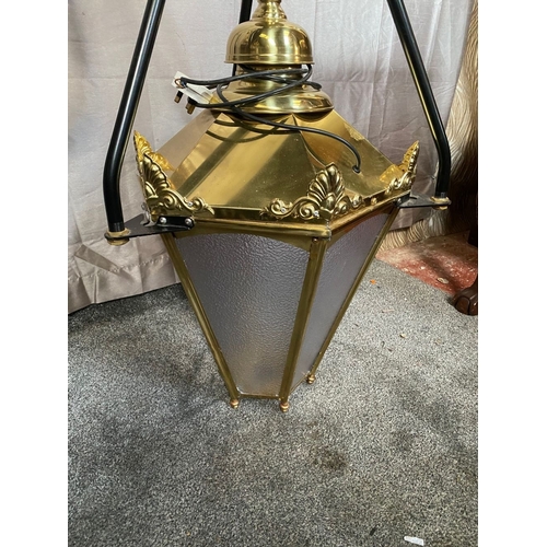 98 - A LARGE BRASS HANGING LANTERN, with black metal tri-bar supports/bracket, the lantern has frosted gl... 