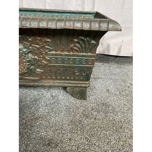 100 - A VICTORIAN CAST IRON GARDEN PLANTER, with tapered body, highly decorated with central panel surroun... 