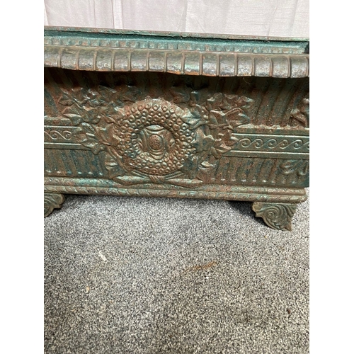 100 - A VICTORIAN CAST IRON GARDEN PLANTER, with tapered body, highly decorated with central panel surroun... 