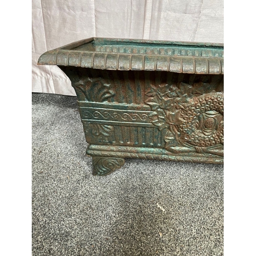 100 - A VICTORIAN CAST IRON GARDEN PLANTER, with tapered body, highly decorated with central panel surroun... 