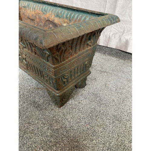 100 - A VICTORIAN CAST IRON GARDEN PLANTER, with tapered body, highly decorated with central panel surroun... 