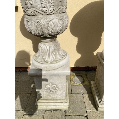 101 - AN EXCELLENT PAIR OF STONE GARDEN URNS, highly decorated with acanthus leaf design to body, standing... 