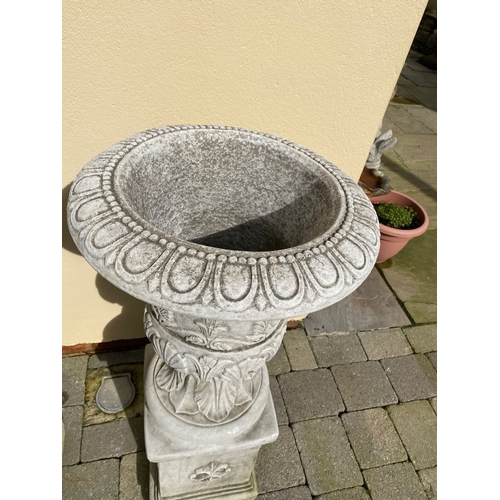 101 - AN EXCELLENT PAIR OF STONE GARDEN URNS, highly decorated with acanthus leaf design to body, standing... 