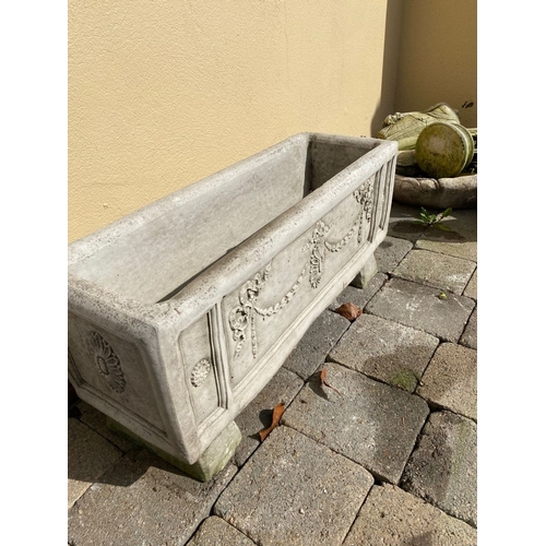 103 - A STONE GARDEN PLANTER, with Adams style decoration, standing on four feet. Dimensions: 76cm x 26cm ... 