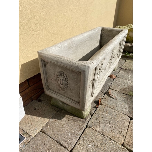 103 - A STONE GARDEN PLANTER, with Adams style decoration, standing on four feet. Dimensions: 76cm x 26cm ... 