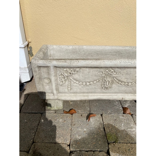 103 - A STONE GARDEN PLANTER, with Adams style decoration, standing on four feet. Dimensions: 76cm x 26cm ... 